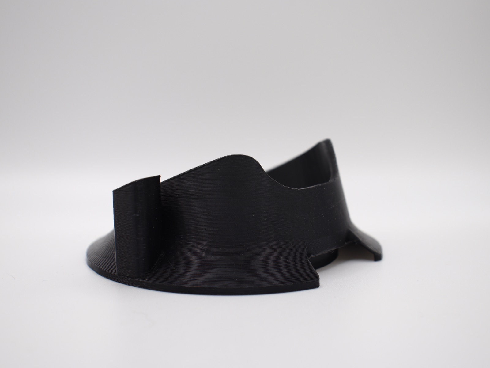 Black glass topper stand viewed from the front.