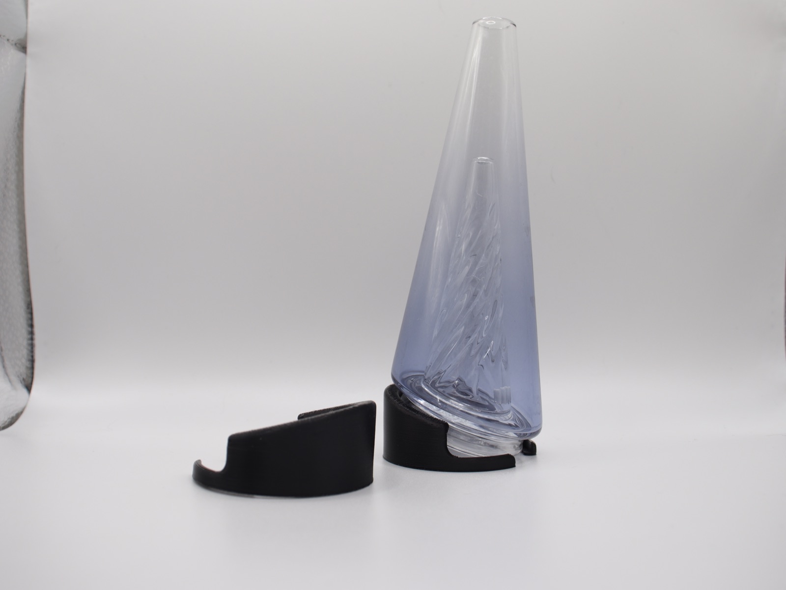Two glass toppers resting upright in black 3D-printed topper stands.